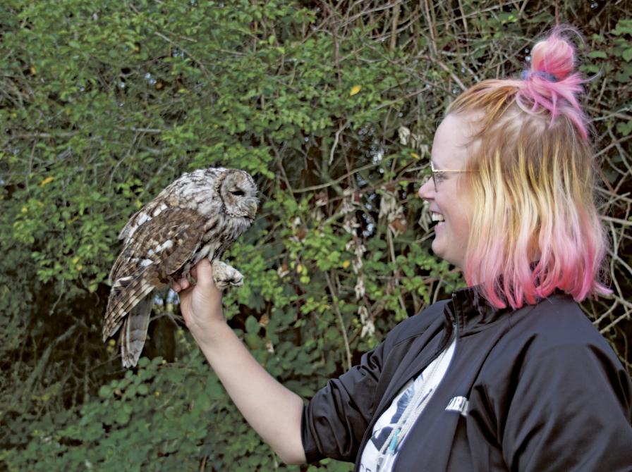 Marie står med ugle